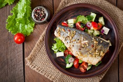 Baked seabass with Greek salad. Top view