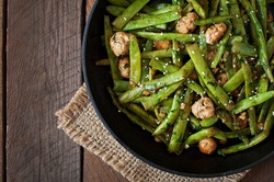 Green beans fried with chicken meatballs and garlic Asian style. top view