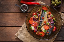 Grilled mackerel with vegetables in Mediterranean style. Top view