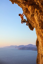 Rock climber on overhanging cliff. Kalymnos Island, Greece. 