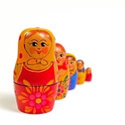 Matryoshka, hand-painted wooden dolls against a white background