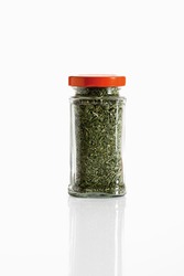 Common thyme in glass jar on white background