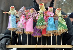Toy effigies of Shrove Tuesday made of straw on wooden stand at Maslenitsa (Butter Lady, Butter Week, Crepe week, or Cheesefare Week) celebrations, Eastern Slavic religious and folk holiday, Russia