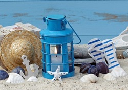 Maritime decoration: lantern, starfish, shells and flip flop shoes.