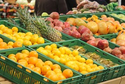 Fruits, oranges, lemons, pomegranates, pineapple and pomelo are sold in the store. Harvest on the market counter.