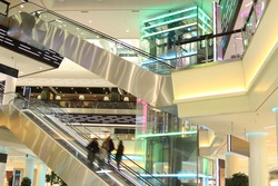 mall with escalators and people in motion