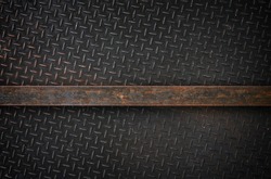 A highly detailed vintage grunge metal diamond background texture with metal bar for your text.