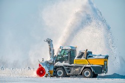 Snow removal vehicle in the airport. Snow blower. Cleaning airport from snow. Cleaning runway from snow