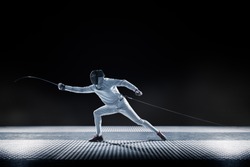 Fencing player isolated on the black background