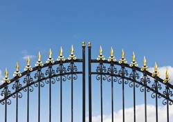 Iron fence opens and closes from the middle.