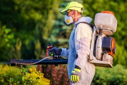 Garden Pest Control Services. Men with Gasoline Pest Control Spraying Equipment. Professional Gardening