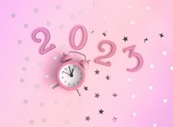 New Years Party Layout with Little Pink Clock, Numbers 2023 and Silver Confetti of Star Shape on a Light Pink Background. Top-Down View. Flat Lay Composition ideal for Banner, Greetings, Card.
