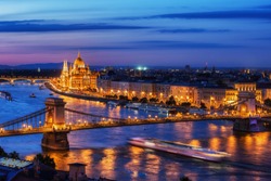Budapest city at blue hour twilight with illuminated Chain Bridge and Hungarian Parliament on Danube River, tranquil evening cityscape.