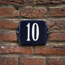 enameled house number ten. white lettering on a blue background