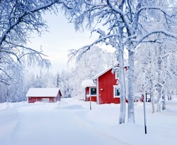 Red house in snow fairy forest. Finland