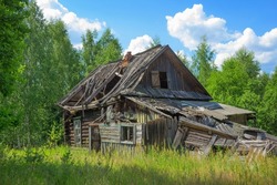 An abandoned wooden old house, desolation and ruin, an old village house among the trees In  fores