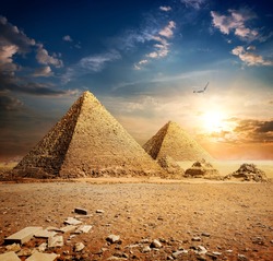 Big bird over pyramids at the sunset