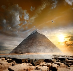 Pyramid of Khafre under storm clouds at sunset