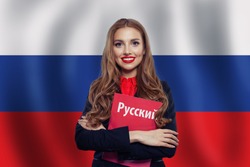 Russia concept with happy woman student with red book on the Russian Federation flag background. Learn russian language. Book with inscription russian on russian language