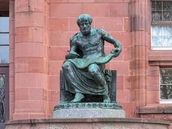 Freiburg im Breisgau, Germany. Aristotle Statue in front of the main building of Freiburg University. The statue was erected in 1921. Greek text on plinth means Aristotle.