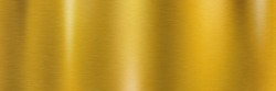 Golden brushed metal surface. Long metallic texture with shiny light reflections for a background