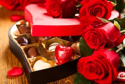 Heart shaped box of chocolate truffles with red roses