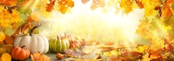 Thanksgiving or autumn scene with pumpkins, autumn leaves and berries on wooden table.  Autumn background with copy space. Banner