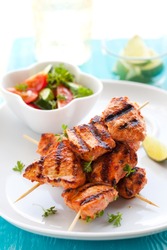 Delicious chicken masala skewers with vegetable salad.
