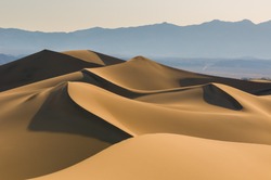 Sand dunes over sunrise sky in Death Valley, California