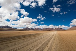 desert road, white clouds and deep blue sky