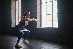 Crossfit healthy concept. Woman wearing sport clothing using resistance band