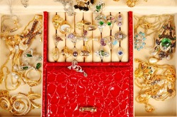 An open jewlery box with gold and platinum  jewelry and accessory close up