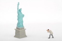 miniature figurine of a photographer taking pictures of the Liberty statue in New York 