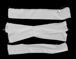 Set white adhesive bandage isolated on black background, top view