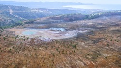 Abandoned site of Limni copper mine, Cyprus aerial landscape. Backfilled open pit with dried pool and colorful spots of chemicals