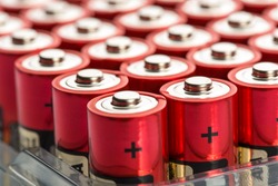 Many red AA batteries in a row