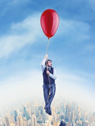 Businessman flying on the big ballon