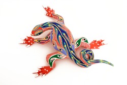 Colorful hand carved lizard. Called Alebrije. Done by street vendors in Oaxaca, Mexico. They are safe to use since the designs have been passed from generation to generation.