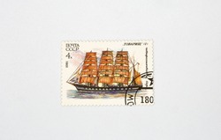Old collectible stamp of the USSR Post with the four-masted barque Comrade closeup against white. Circa 1981.