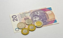 Polish twenty zloty fifty banknote and coins closeup against white