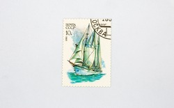 Old collectible stamp of the USSR Post with the schooner Kodor closeup against white. Circa 1981.