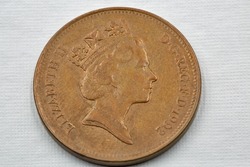 Old used British two pence coin 1992 closeup against white. Portrait if Queen Elizabeth II.