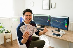 Successful man screaming with happiness while earning a lot of money for investing in the stock market and cryptocurrency