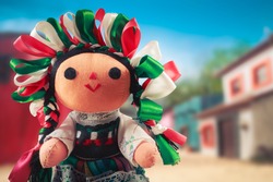 Mexican rag doll in a traditional dress on a mexican village