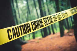Crime scene tape in the woods / Selective focus