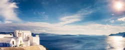 Panorama view of Santorini island in Greece, on a sunny day with beautiful sky. Scenic travel background.