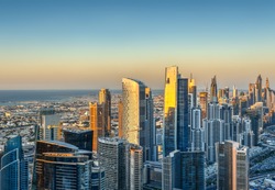 Beautiful skyline with modern architecture at sunset. Aerial view of Dubai business bay towers.