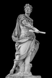 Roman emperor Julius Caesar statue isolated over black background