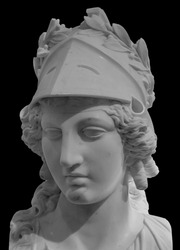 Ancient Greek goddess Athena Pallas statue isolated on black. Marble woman head in helmet sculpture.