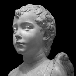 Ancient roman marble portrait of a boy. Young man head statue isolated on black background. Antique sculpture